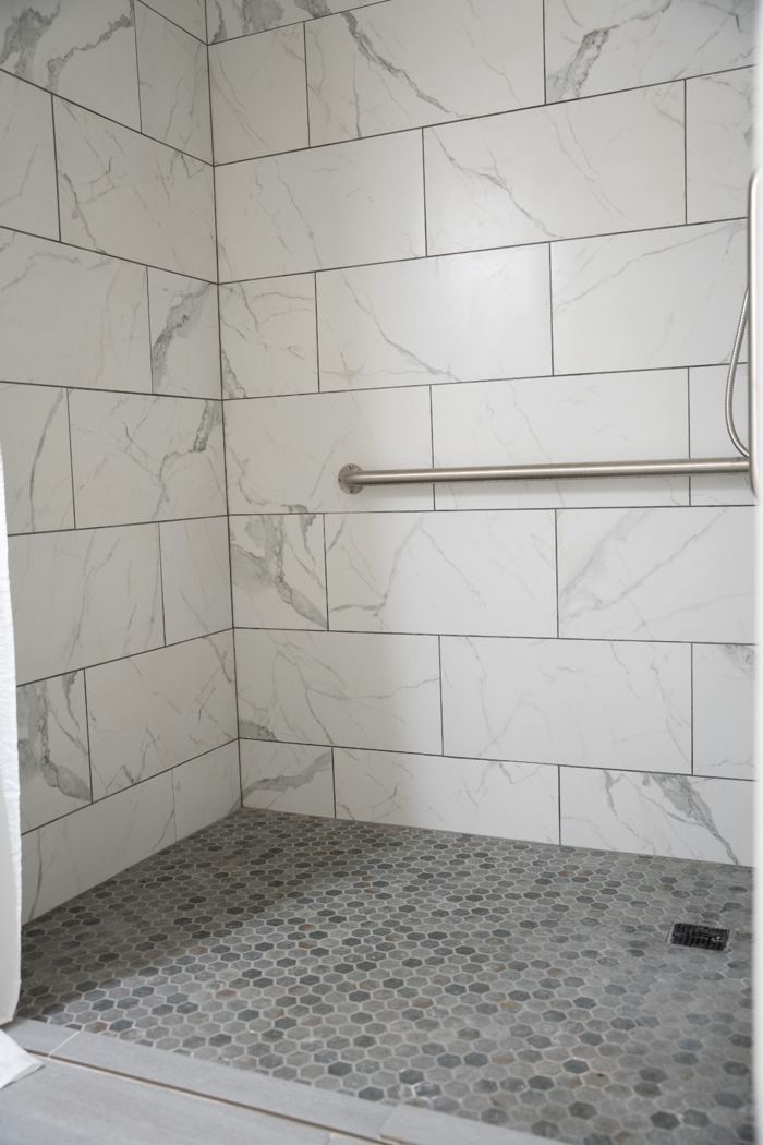 Walk-in shower with grab bar